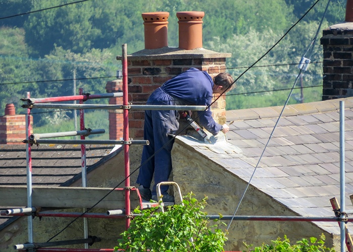 man fixing chimney
